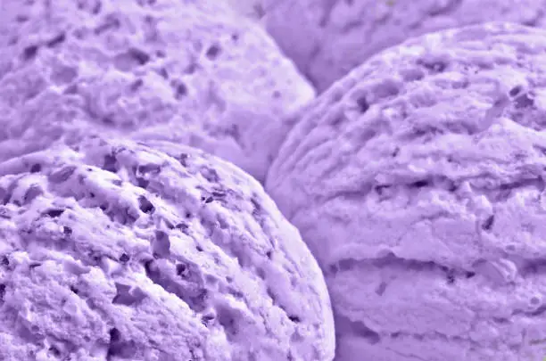 Purple blueberry ice cream balls, extremely  close up, as a background texture
