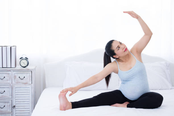 istock Pregnant woman doing yoga exercise. 1158520100