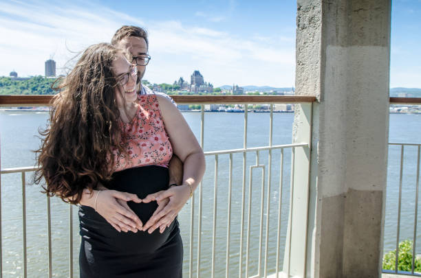 istock Young pregnant woman held by man 1158521077