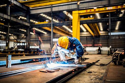 Welder working in a factory.