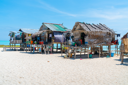 Small group gypsy stilt homes on small tropical island with all their possessions and children May 2019 Sabah Borneo.