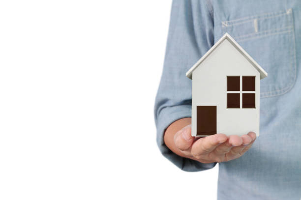 istock Mortgage concept by house from hand 1158528842