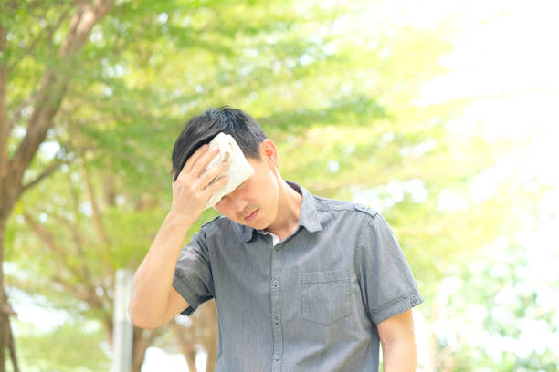 Men working outdoors He has a headache. Because of the hot weather Men working outdoors He has a headache. Because of the hot weather hyperthermia photos stock pictures, royalty-free photos & images