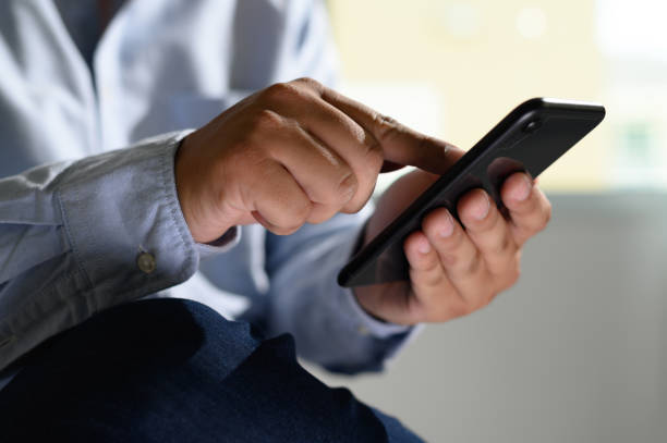 istock man holding en hands and using digital tablet  Mobile Phone telephone with blank copy space scree 1158530150