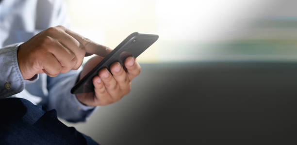 istock man holding en hands and using digital tablet  Mobile Phone telephone with blank copy space scree 1158530178