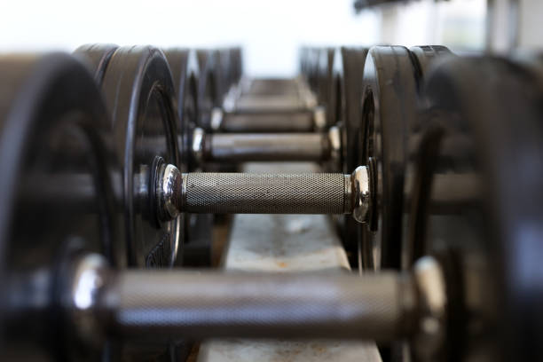 istock Heavy black metal dumbbells lying in a row, closeup 1158534288