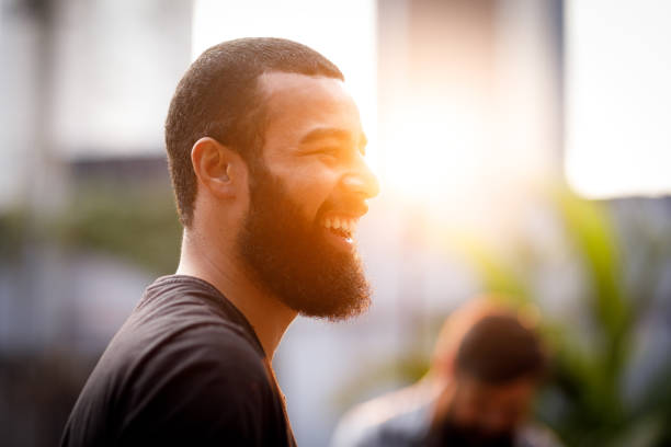 istock Man laughing in a party at sunset 1158538132
