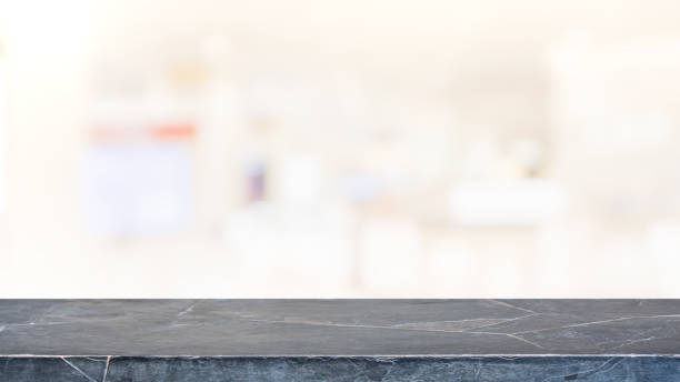 istock Empty black marble stone table top on blur bokeh cafe and restaurent interior background - can be used for display or montage your products 1158540055
