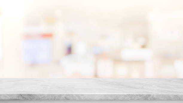 istock Empty white marble stone table top on blur bokeh cafe and restaurent interior background - can be used for display or montage your products 1158540067