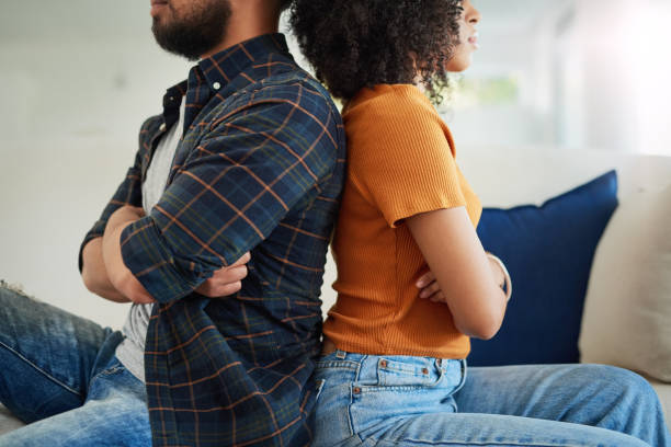 They've turned their backs on constructive communication Shot of a young couple having a disagreement at home fighting stock pictures, royalty-free photos & images