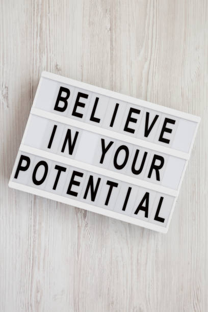 istock 'Believe in your potential' words on a lightbox on a white wooden surface, top view. Flat lay, overhead, from above. Closeup. 1158542160