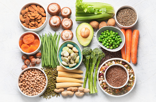 Food sources of plant based protein. Healthy diet with  legumes, dried fruit, seeds, nuts and vegetables.  Foods high in protein, antioxidants, vitamins and fiber.