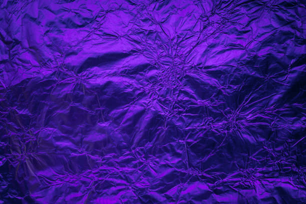 istock Violet purple deformed background made of illuminated foil 1158543233