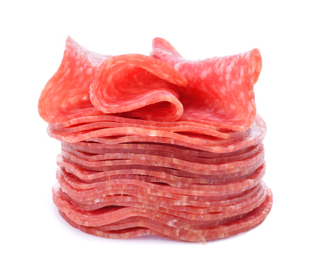 Salami sausage sliced in stack isolated on white