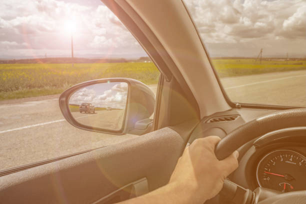 istock Car trip. Road view reflection on side mirror. Sunshine toned photo 1158543379