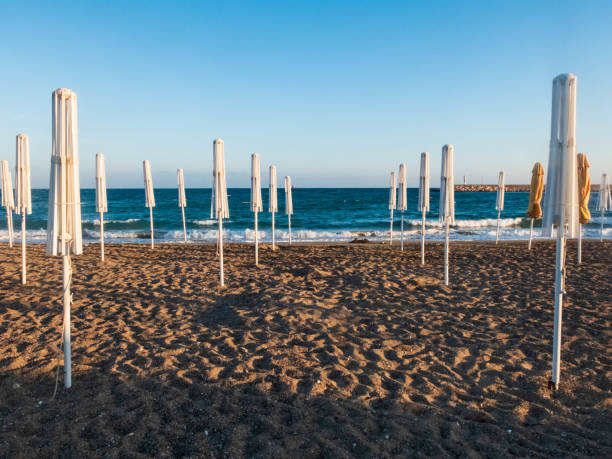 istock Folded umbrellas on the sandy beach of Mediterranean Sea 1158544159