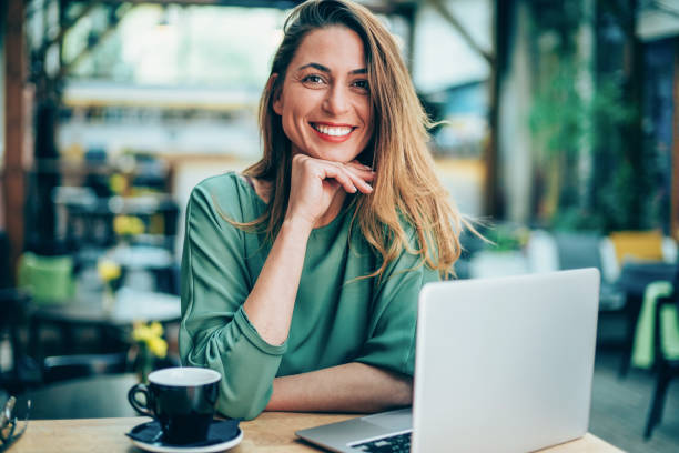istock Woman working on laptop at a cafe 1158550272