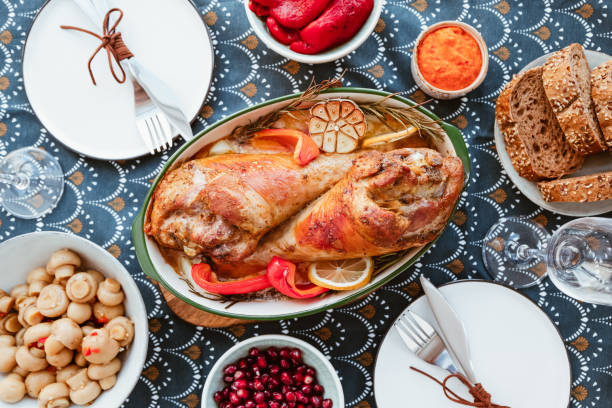 istock Festive dish for Thanksgiving, roasted turkey legs with vegetables on a table with snacks. Top view, flat lay. 1158550327