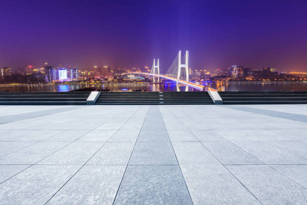 istock Empty square floor and bridge buildings at night in Shanghai 1158550342