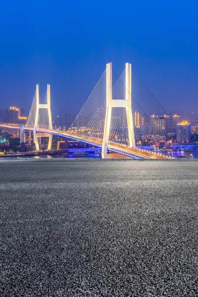 istock Empty road and Nanpu bridge at night in Shanghai 1158551408