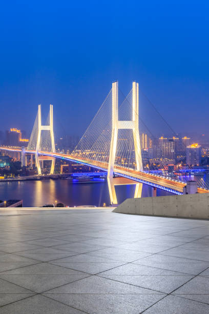 istock Empty square floor and bridge buildings at night in Shanghai 1158551653