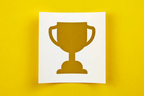 istock White Paper With Winner Trophy Symbol On Yellow Background 1158553930
