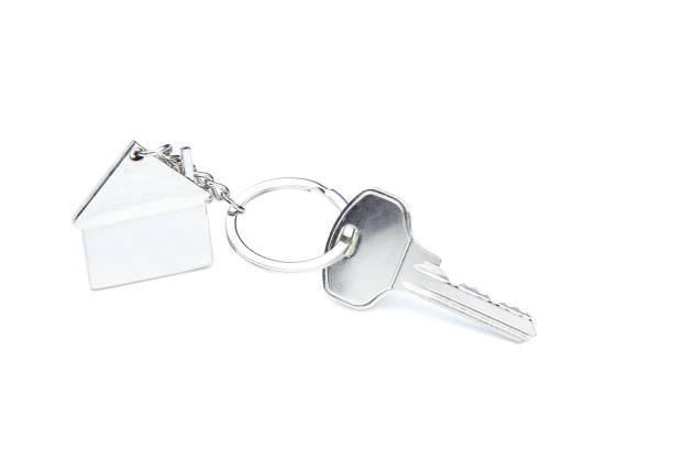 istock Silver key with house symbol isolated on white background 1158557125