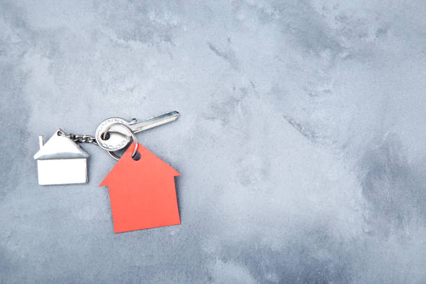 istock Silver key with house symbol on gray background 1158557260