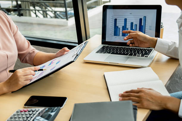 istock Business adviser analyzing financial figures denoting the progress Internal Revenue Service checking document. Audit concept 1158557331