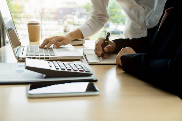 istock Business adviser analyzing financial figures denoting the progress Internal Revenue Service checking document. Audit concept 1158557342