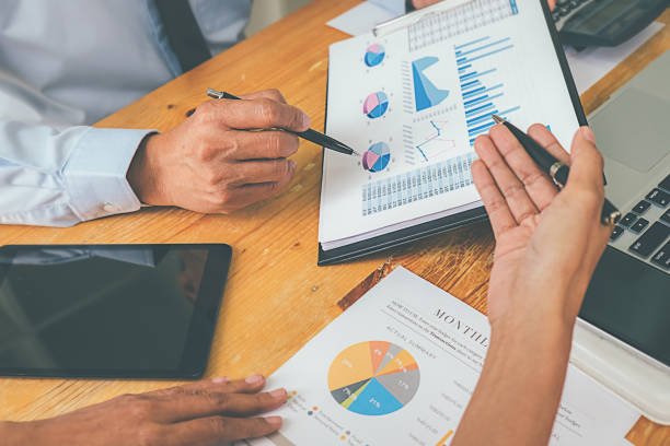 istock Business advisor analyzing financial figures denoting the progress Internal Revenue Service checking document. Audit concept 1158557343