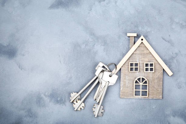 istock Silver keys with house symbol on gray background 1158557931