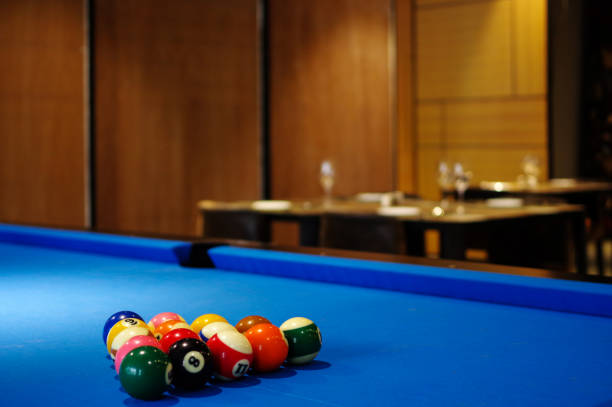 Blue pool table and billiard balls set up in restaurant bar