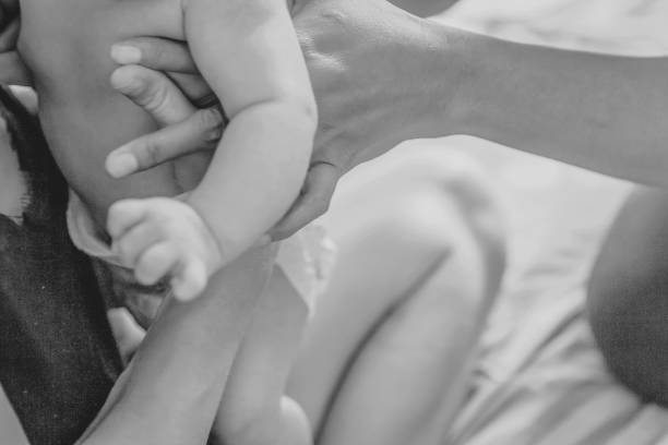 istock Young women hugging newborn baby 1158557978
