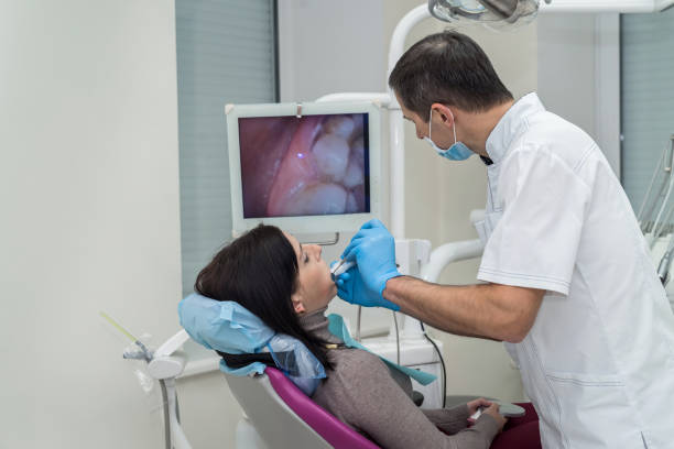 dentist checking patient's teeth with camera in stomatology - medical exam dental hygiene caucasian mask imagens e fotografias de stock