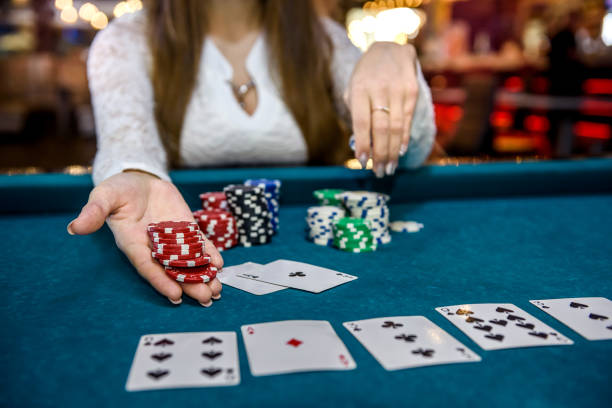 istock Female hands with playing cards and poker chips 1158558078