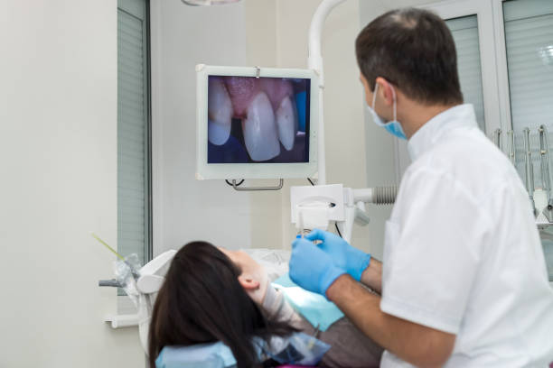 dentist checking patient's teeth with camera in stomatology - medical exam dental hygiene caucasian mask imagens e fotografias de stock