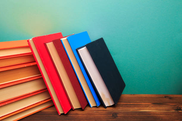 istock pile of old books panorma, good copy space  on blue background - Image 1158558469