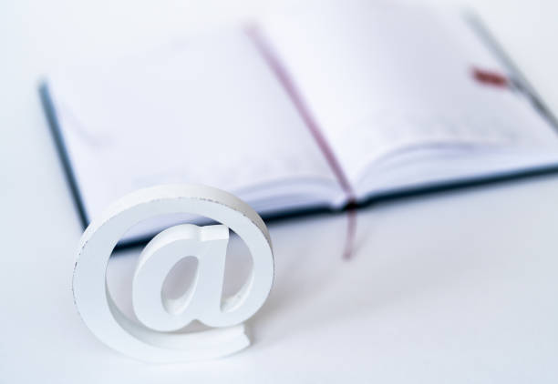 istock E-mail symbol ageinst a notebook on a desktop. Concept for email, communication or contact us 1158560130