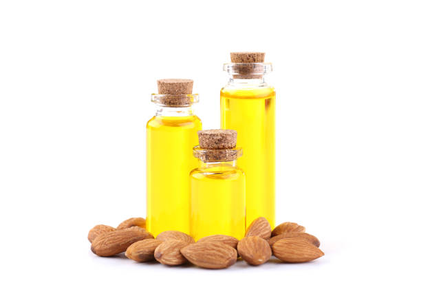 istock Almond and oil in bottles on white background 1158560175