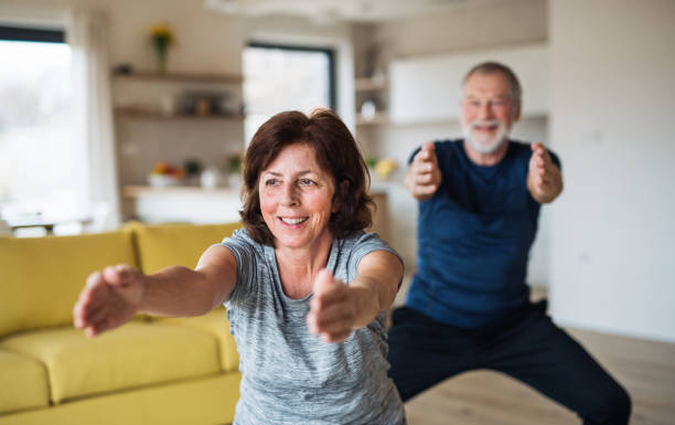 istock A senior couple indoors at home, doing exercise indoors. 1158571384