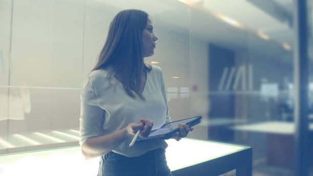 istock Young woman Librarian writing on tablet 1158571924