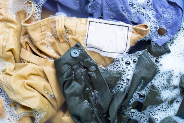 istock Trousers soak in powder detergent water dissolution. Laundry concept 1158571951