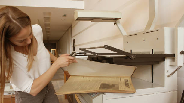istock Young woman modern Librarian scanning a book 1158572594