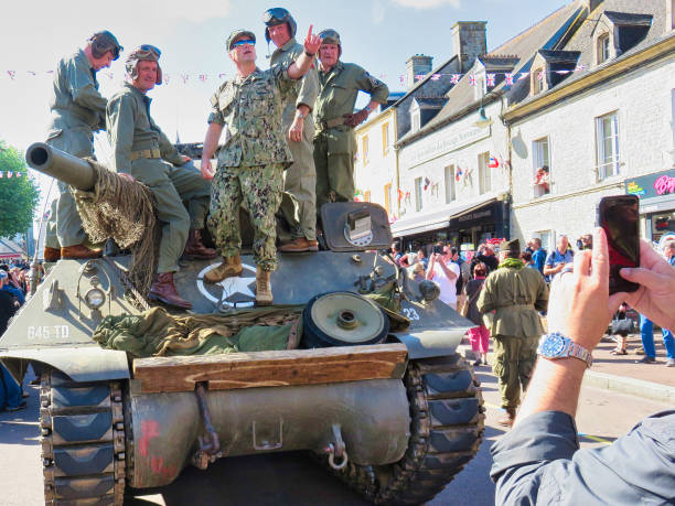 D-Day remembrance 75 birthday in Normandy, France 2019. SAINTE MERE, NORMANDY, FRANCE - JUNE 06, 2019. D Day 75 birthday of french liberation by allied countries. Ceremony to remind what american, british, canadian soldiers did during world war two. Scene of life with miltary tank in 1944 France caen photos stock pictures, royalty-free photos & images