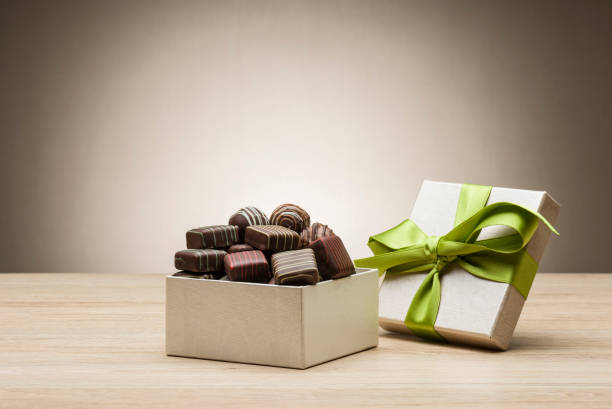 variety of chocolates mix of chocolates and praline in their gift box chocolate pieces stock pictures, royalty-free photos & images