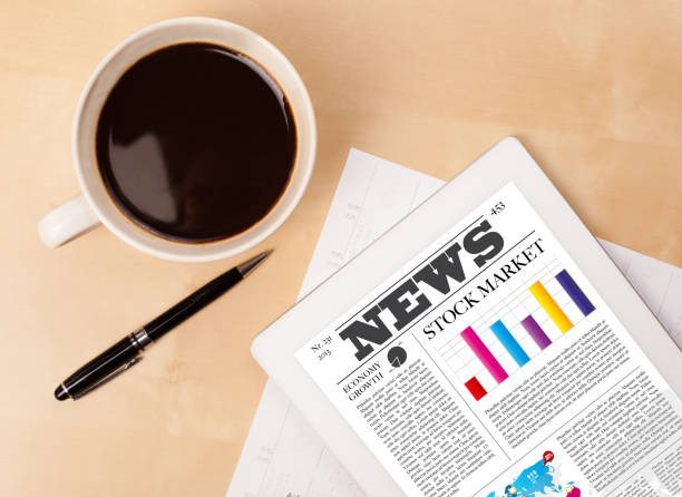 istock Tablet pc shows news on screen with a cup of coffee on a desk 1158573107