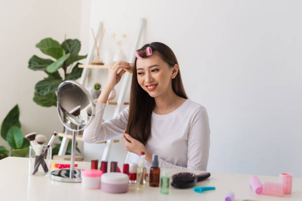 istock Young female blogger with combs recording video at home 1158574307
