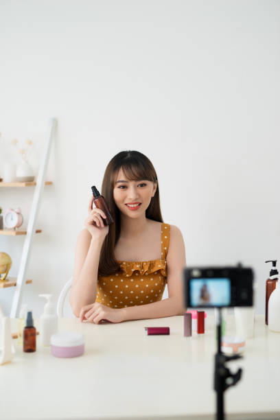 istock Useful beauty blog. Nice attractive woman giving advice about cosmetics while having her beauty blog 1158574341