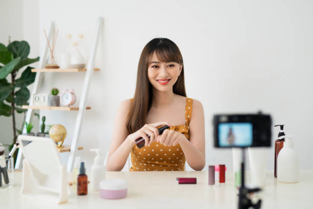 istock Useful beauty blog. Nice attractive woman giving advice about cosmetics while having her beauty blog 1158574352